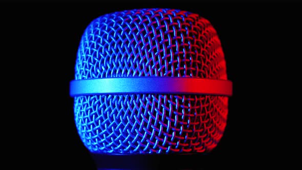 Microphone Rotates with Blue and Red Backlight. Dynamic Microphone Grid Spins Close-up