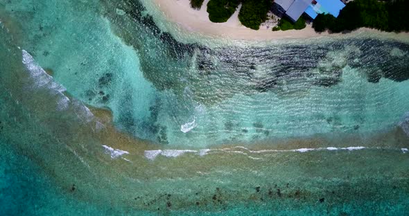 Natural above abstract shot of a sandy white paradise beach and aqua blue ocean background 