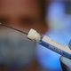 Closeup of a medical with face mask filling syringe with a covid-19 vaccine. - VideoHive Item for Sale