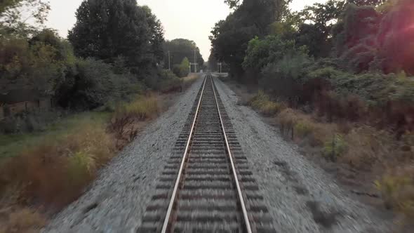 Drone flying over Railroad Tracks near Sunset