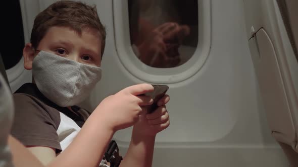 Boy in Mask on Airplane