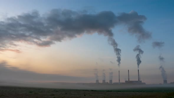 Timelapse plant thermal power plant working with pipes and smoke on a background of dawn.