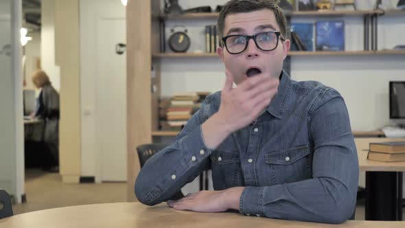 Shocked Creative Man Wondering and Working on Laptop