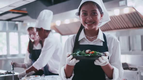 Group of schoolgirls having fun learning to cook. Female students in a cooking class.