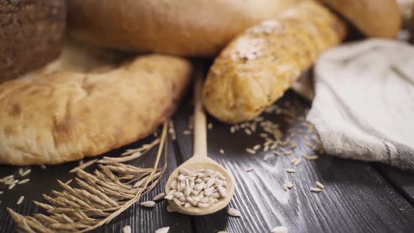 Woman Puts Whole Homemade Bread on Wooden Table, Slow Motion