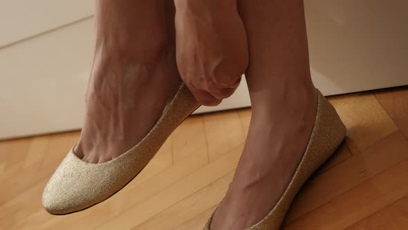 Female tries  elegant evening shoes 4K 2160p 30fps UltraHD  footage - Woman is trying golden colour 