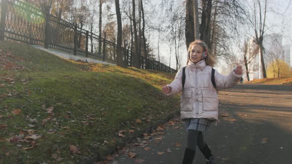 Cheerful Schoolgirl Running Bouncing on the Way Home