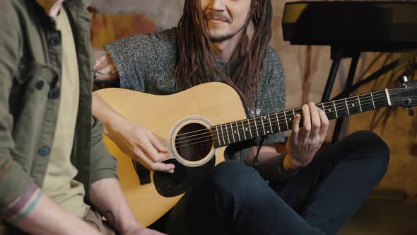 Two Men Friends Playing Music Laughing to Each Other Drummer and Guitarist Performing Together at