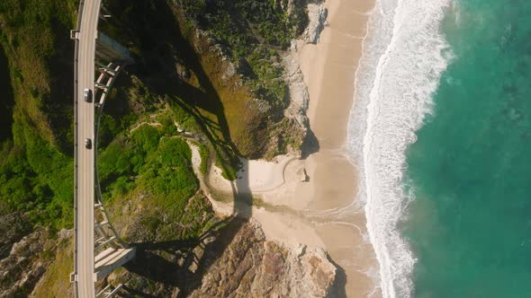 Green Ocean Waves Crashing Under Bixby Bridge at Big Sur Scenic Road Drone