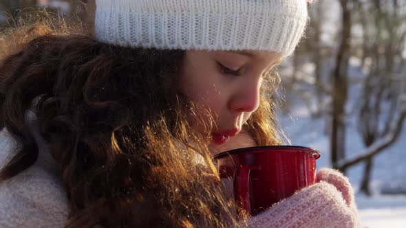 Little Girl with Cup of Hot Tea in Winter Park