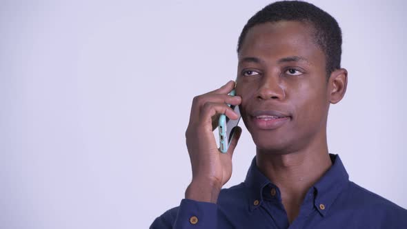 Face of Young Happy African Businessman Talking on the Phone