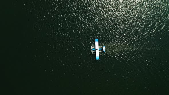 Aerial top down, seaplane floating on ocean lake water