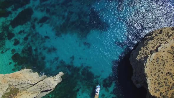 an aerial view of a boat in blue lagoon malta