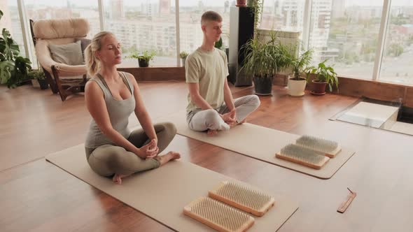 Partners Meditating At Yoga Class