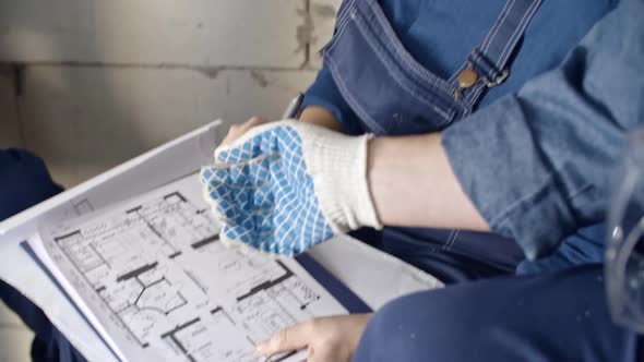 Construction Laborers Discussing Layout Plan