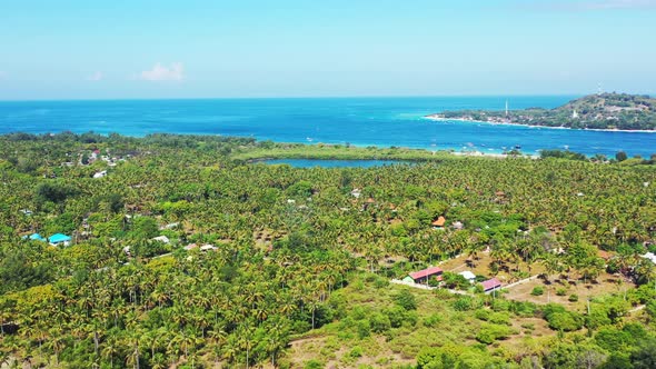 Daytime aerial island view of a white sandy paradise beach and blue water background in colorful