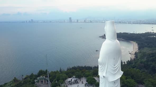 Aerial View White Buddha Statue on Ocean Coast Hilltop