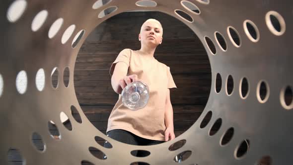 Young Woman with Short White Hair Walks Over to Trash Can and Throws Out Plastic Bottle Sorting