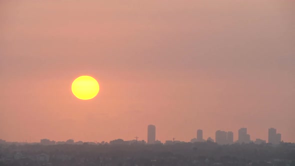 Time lapse of clouds from a low angle shot of skyscrapers in Tel Aviv