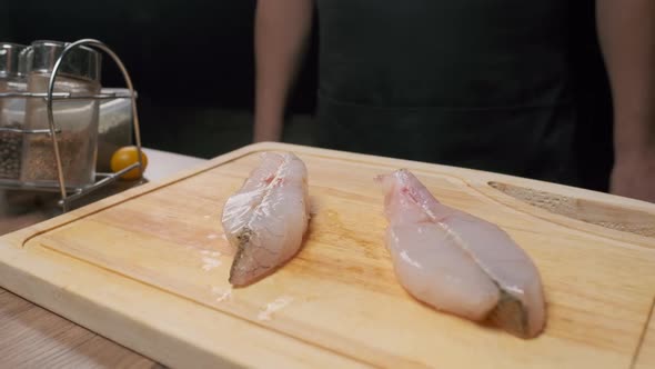 Professional Chef Prepares Fish Steak for Frying