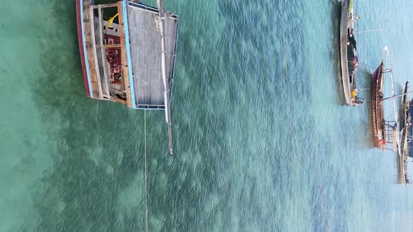 Vertical Video Boats in the Ocean Near the Coast of Zanzibar Tanzania Aerial View