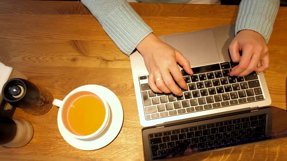 Overhead View Woman Typing on Laptop Keyboard Sitting in Cafe