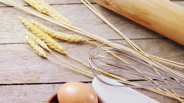 Brown eggs, barley crop and various ingredients on wooden table