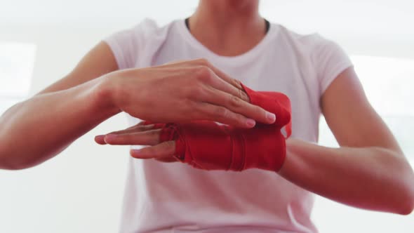 Caucasian woman putting strap around her wrists