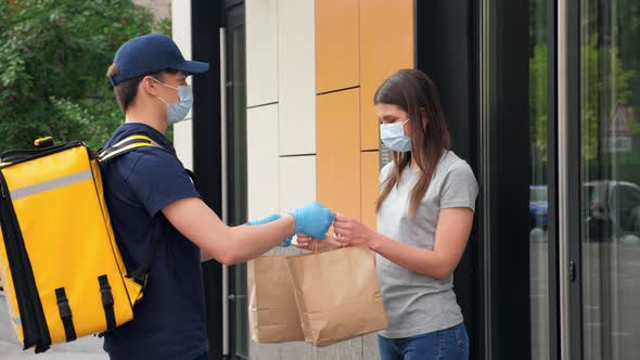 Delivery Man Wears Face Mask and Gloves to Deliver Order Masked Woman Customer