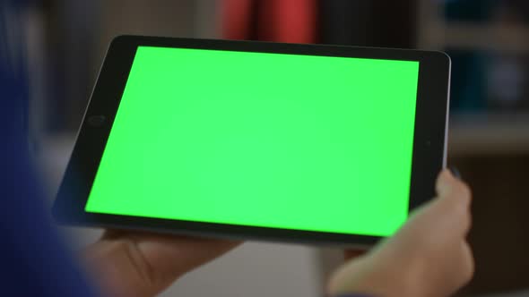 African American Woman Holding Tablet Digital Device Green Screen in Home Office