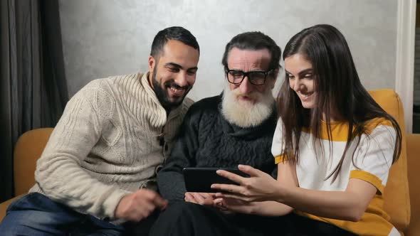 Grandchildren Show Photos To Grandpa