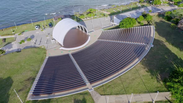 Aerial top down shot of empty amphitheater in Puerto Plata during sunny day and Caribbean Sea in bac