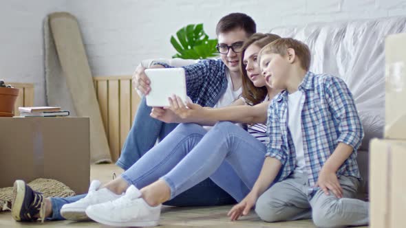 Young Family Taking Pictures on Tablet