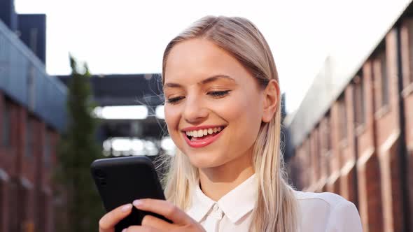 Adorable Beautiful Woman Checking Emails on Smartphone Outdoors