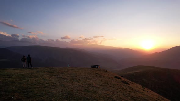 A Few People on the Hill are Watching the Sunset