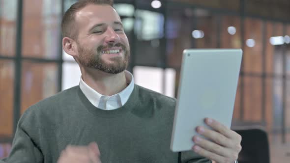 Portrait Shoot of Young Man Doing Video Chat on Tablet