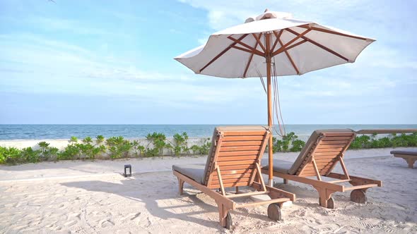 Beautiful tropical sea beach around with umbrella chair on blue sky