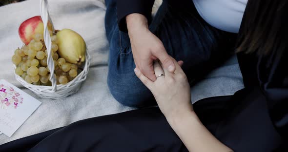 Man Woman Hold Hands Wedding Rings Sitting Plaid Basket Fruits