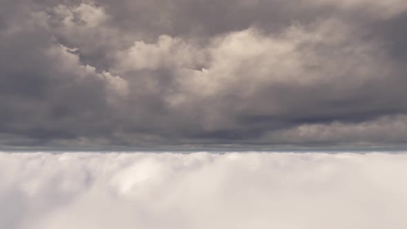 Flying Through White Gray Clouds In The Dark Sky