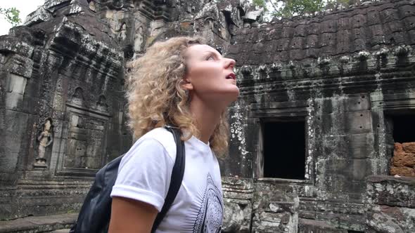 Young Woman Tourist Sightseeing In Ancient Temple Of Angkor