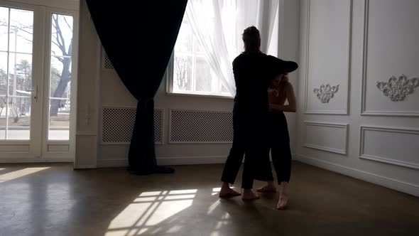 a Young Barefoot Couple is Dancing in a Spacious Bright Room