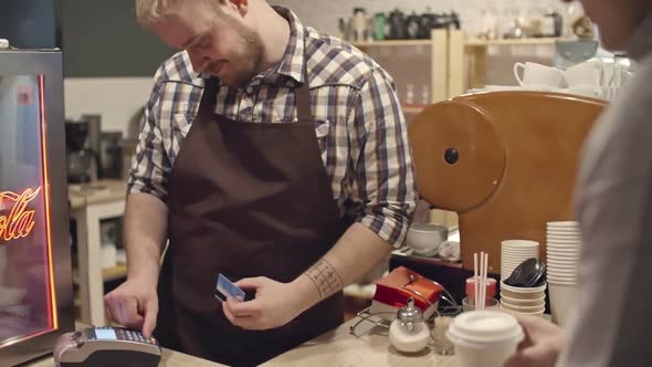 Barista Receiving Payment for Coffee