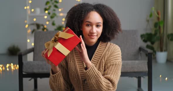 Afro American Teenager Birthday Girl Receives Parcel From a Courier Present Home Delivery Holds Red