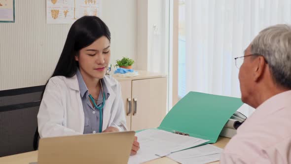 Doctor measuring blood pressure of elderly man in medical office