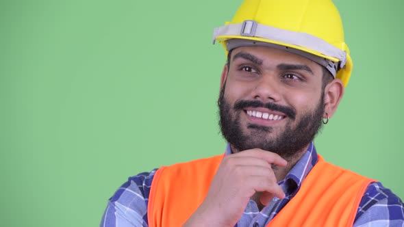 Face of Happy Young Overweight Bearded Indian Man Construction Worker Thinking and Looking Up