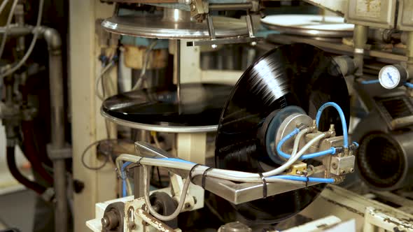 Industrial placing of vinyl record in sleeve in a record factory