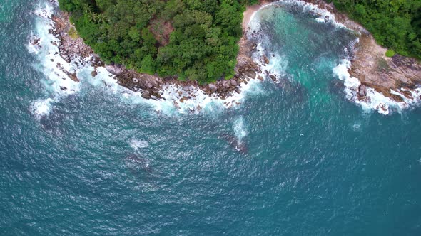 Top view seashore rocks in Phuket ocean Sea waves crashing on rocks cliff seascape Aerial view