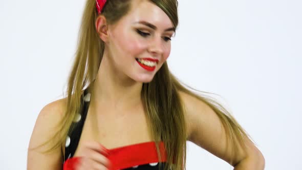 A Beautiful 50s Pin up Girl Spins Around, Dances and Smiles at the Camera, Closeup