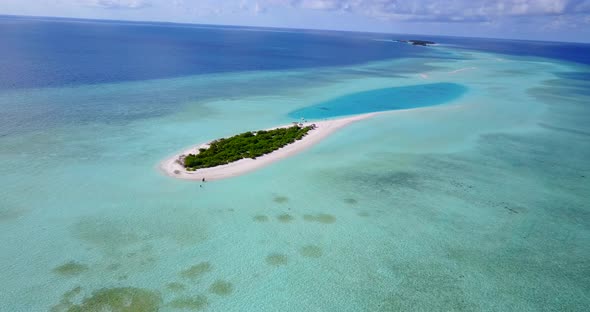 Wide angle aerial clean view of a white sand paradise beach and blue water background in colourful 