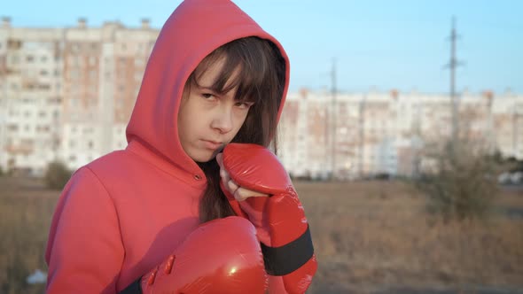 Teen in boxing glove. 